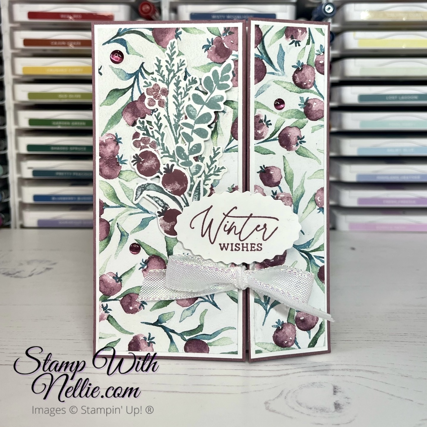 Photo of a mauve and green floral fun fold card. The sentiment reads Winter Wishes.